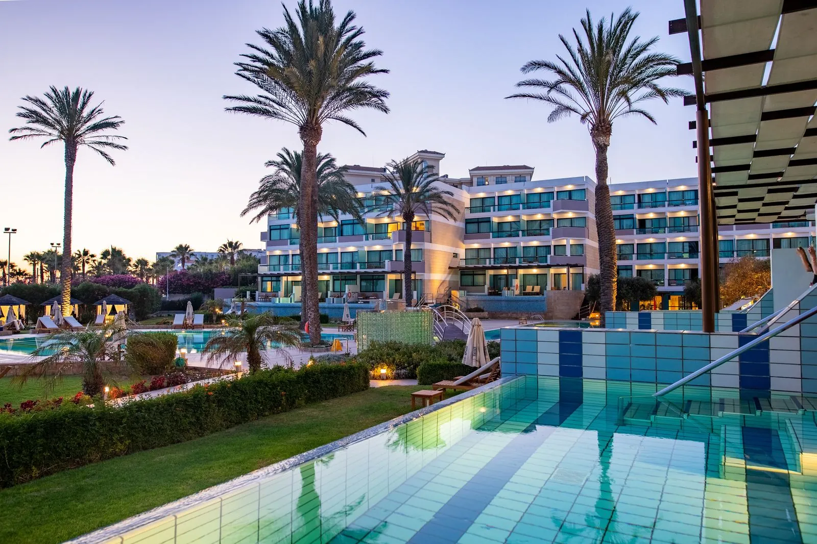 Pool of Asimina Suites at dusk