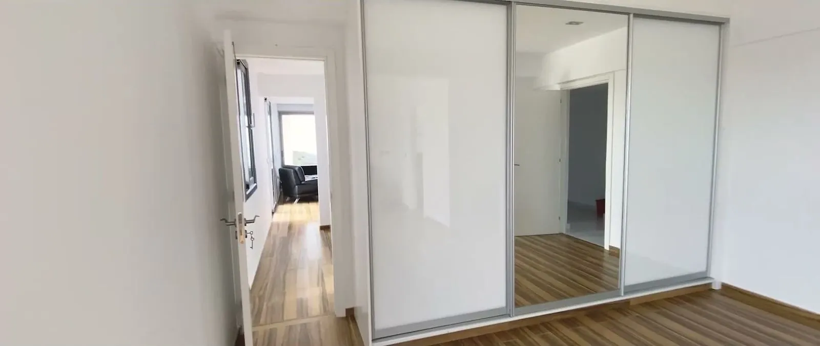 Hallway with fitted wardrobes, still from the image film
